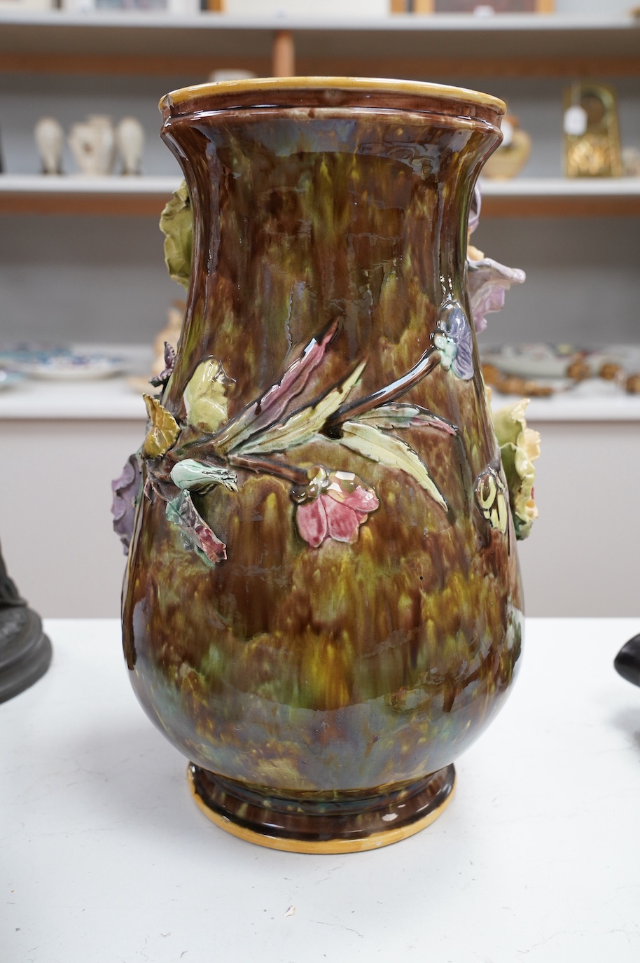 A large majolica floral decorated vase, 39cm. Condition - fair, several chips